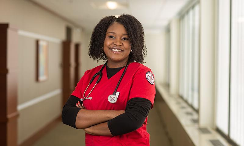 Adult Accelerated nursing student poses in a hallway